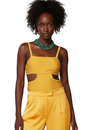 Person wearing a yellow outfit with cut-out design on a white background
