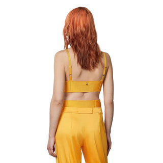 Person wearing a yellow outfit with a plain background