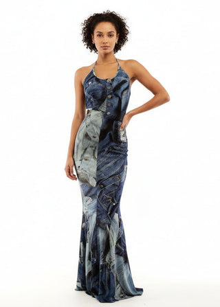 Woman wearing a long, dark blue dress with a unique pattern on a white background