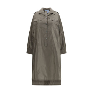 A long-sleeve utility shirt dress in a muted olive-brown color, featuring a button-up front, flap chest pockets, and shoulder epaulets, shown against a plain white background.